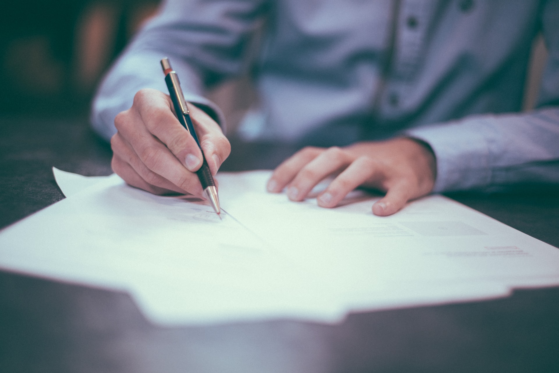 person writing official document feature